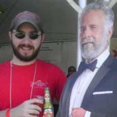 The author of Passable Beer Reviews standing next to a cardboard cutout of the former Most Interesting Man in the World.